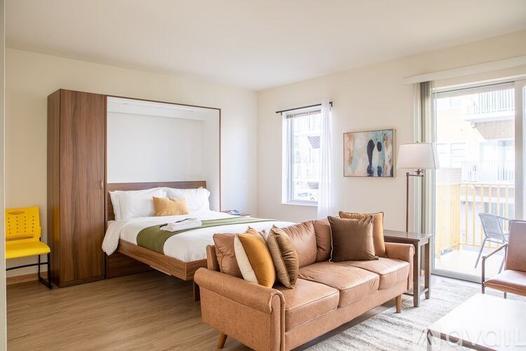 A bedroom with a large bed and a couch.