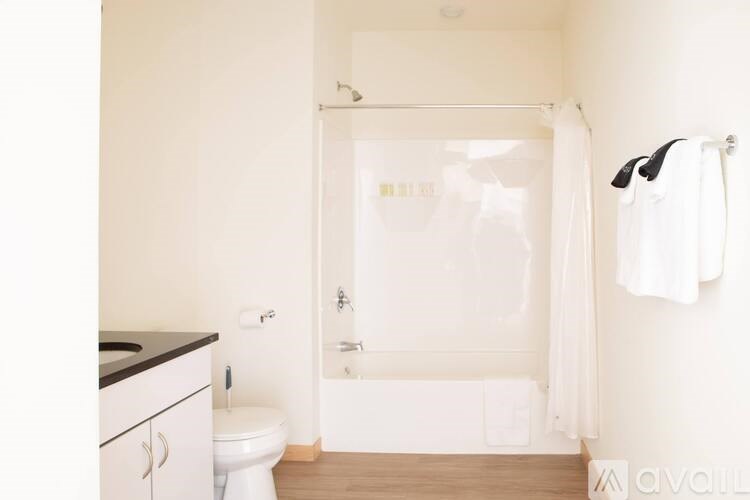 A white bathroom with a toilet, sink, and bathtub.