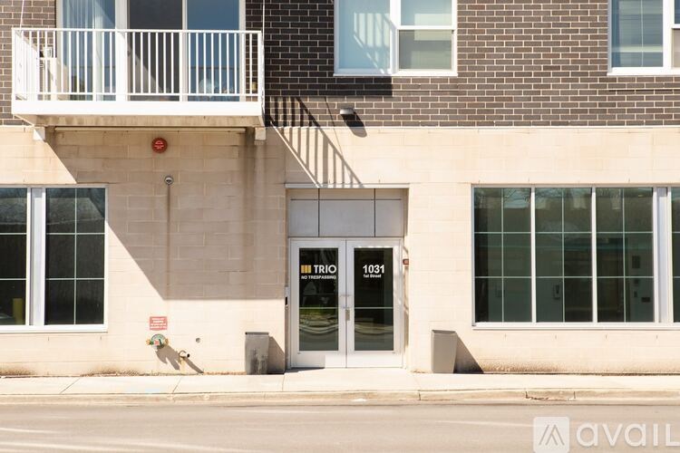 A building with a balcony and a door with a glass window.