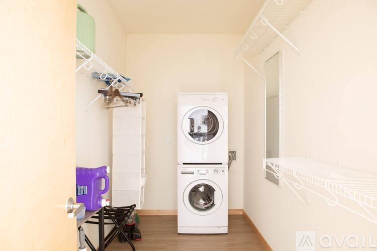 A small laundry room with a washer and dryer.