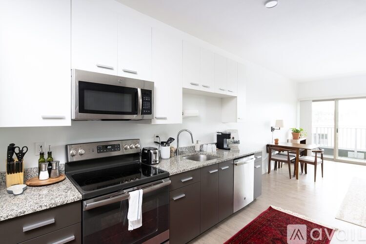A modern kitchen with a black stove top oven and microwave.