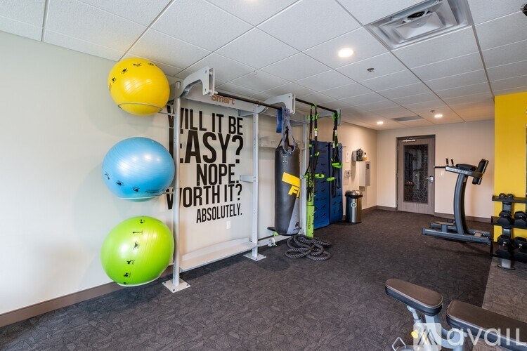 A gym with a sign that says "Will it be easy? No, it's worth it. Absolutely."