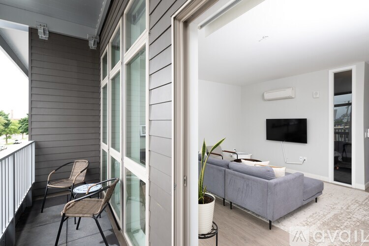 A balcony with a chair and a potted plant.