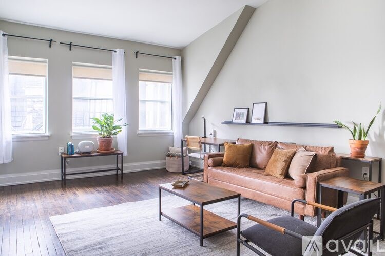 A living room with a brown couch and a coffee table.