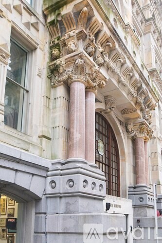A building with a large arched doorway and a clock on the wall.