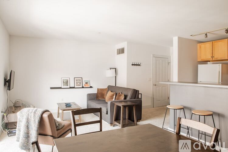 A living room with a couch, chairs, and a coffee table.