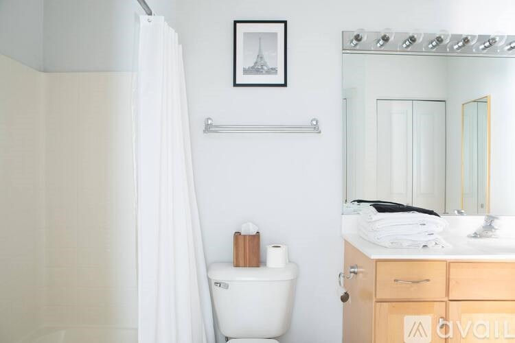 A white toilet sits next to a sink in a bathroom.