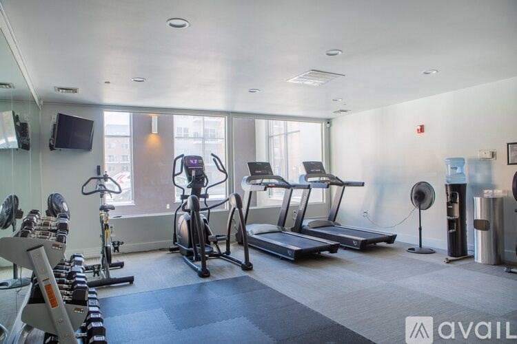 A gym with treadmills, exercise bikes, and other equipment.