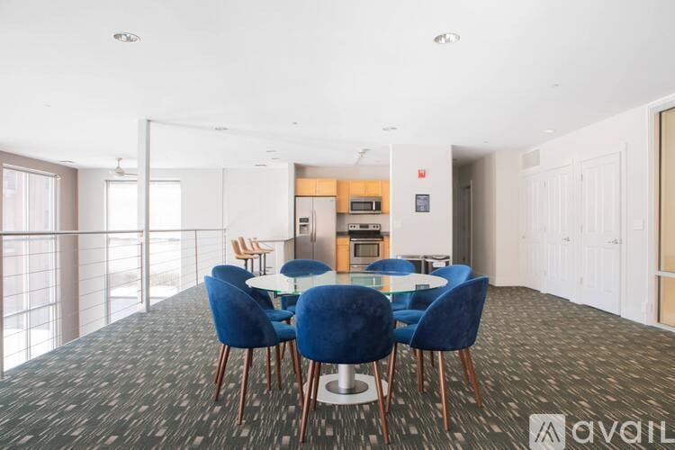 A dining room with a table and chairs.
