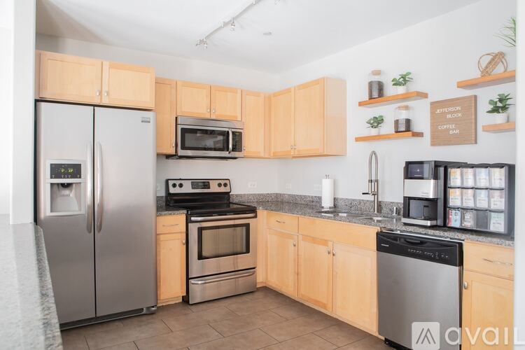 A kitchen with wooden cabinets and stainless steel appliances.