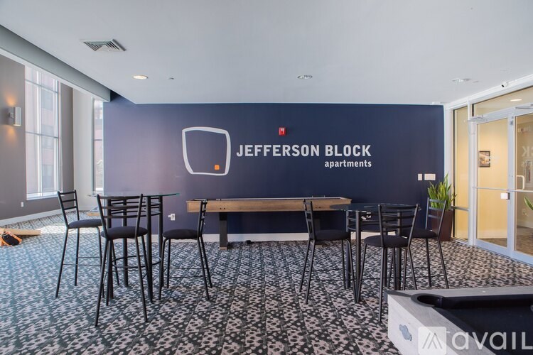 A conference room with a long table and chairs, and a sign that says "Jefferson Block apartments".