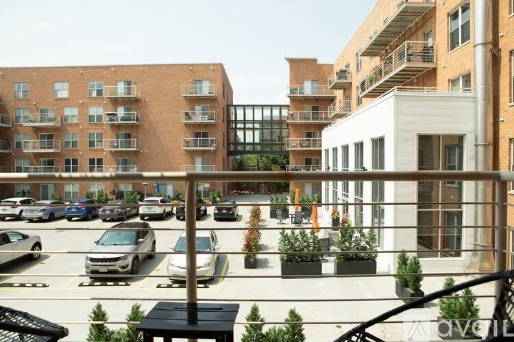 A parking lot with cars and apartment buildings in the background.