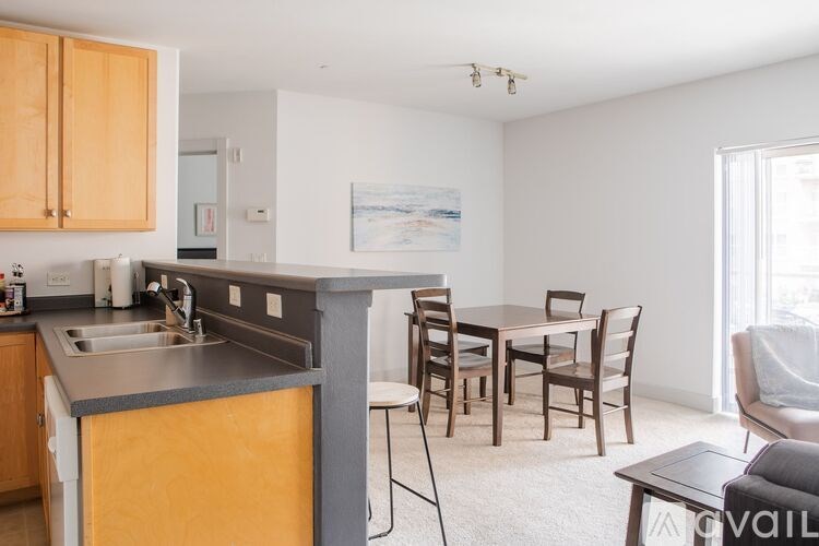 A kitchen with a dining table and chairs.