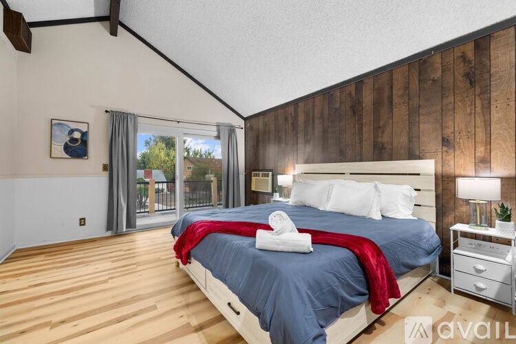 A bedroom with a large bed and a wooden headboard.