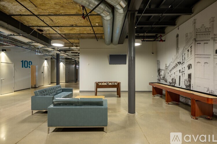 A room with a long table and chairs in the middle of the room.
