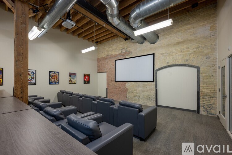 A room with a long table and chairs, a whiteboard, and pictures on the wall.