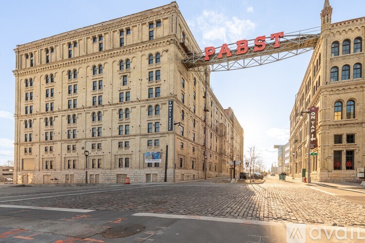 A large building with the word PABST on a bridge above it.