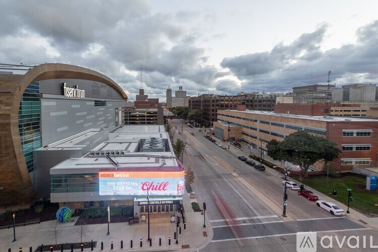 A view of a city street with a building that has a sign that reads "The Official Chili".