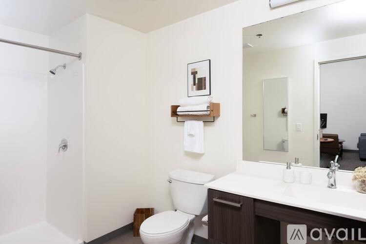 A white toilet sits in a small bathroom next to a sink.