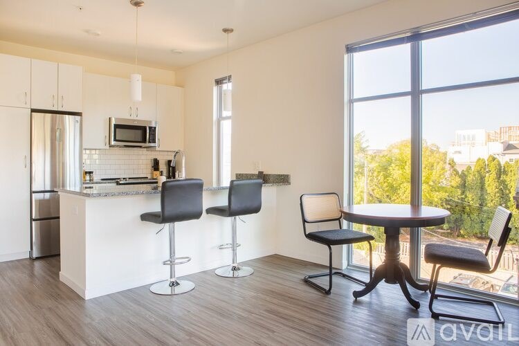 A kitchen with a bar area and a dining table.