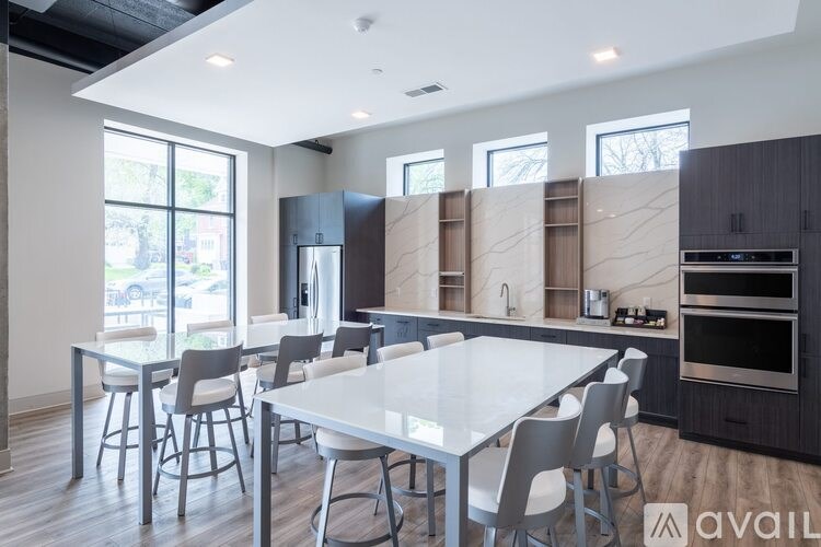 A modern kitchen with a dining table and chairs.