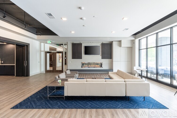 A modern living room with a fireplace and a large couch.