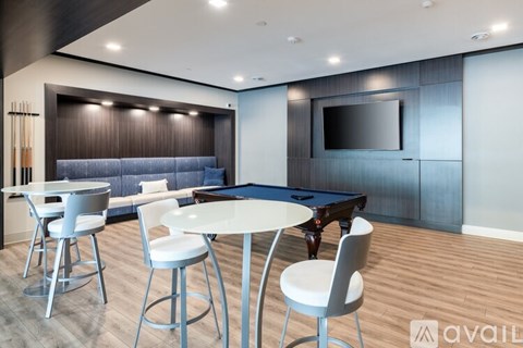 A modern living room with a pool table and a television.