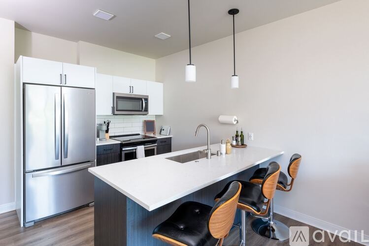 A kitchen with a white countertop and a refrigerator.