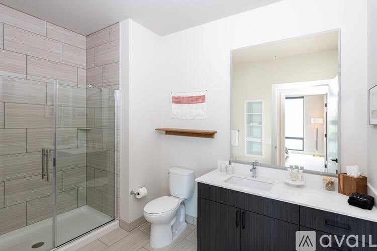 A bathroom with a toilet, sink, and shower.