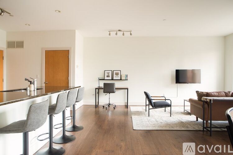 A modern living room with a bar area and a television.