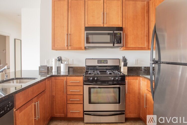 A kitchen with wooden cabinets and stainless steel appliances.