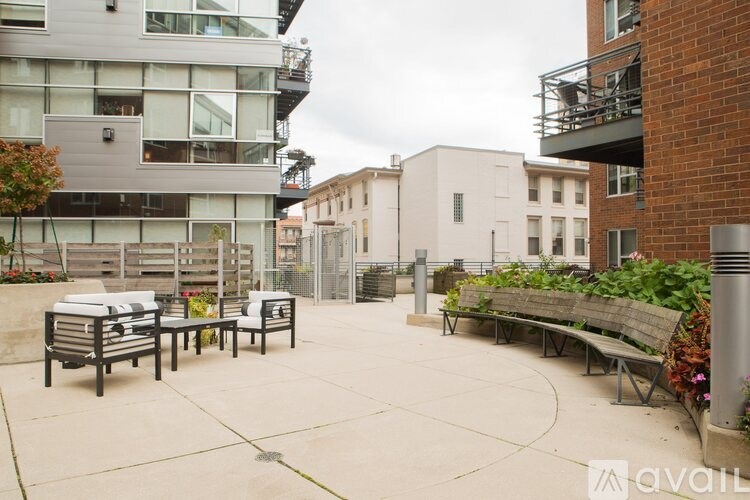 A patio area with a table and chairs surrounded by buildings.