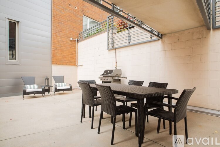 A patio with a table and chairs is set up outside a building.
