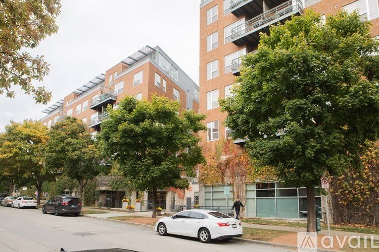 A street view of a residential area with cars and buildings.