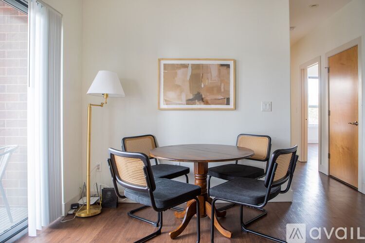 A dining room with a round table and chairs.
