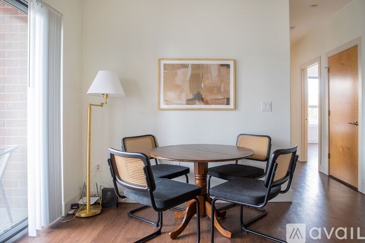 A dining room with a round table and chairs.