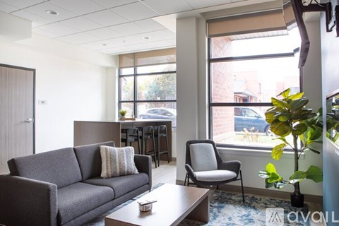 A living room with a grey couch and a coffee table.