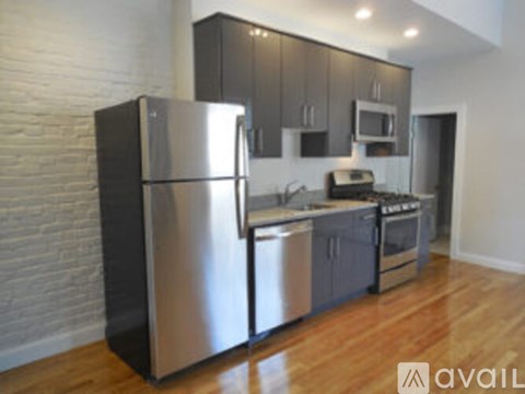 A modern kitchen with a stainless steel refrigerator.