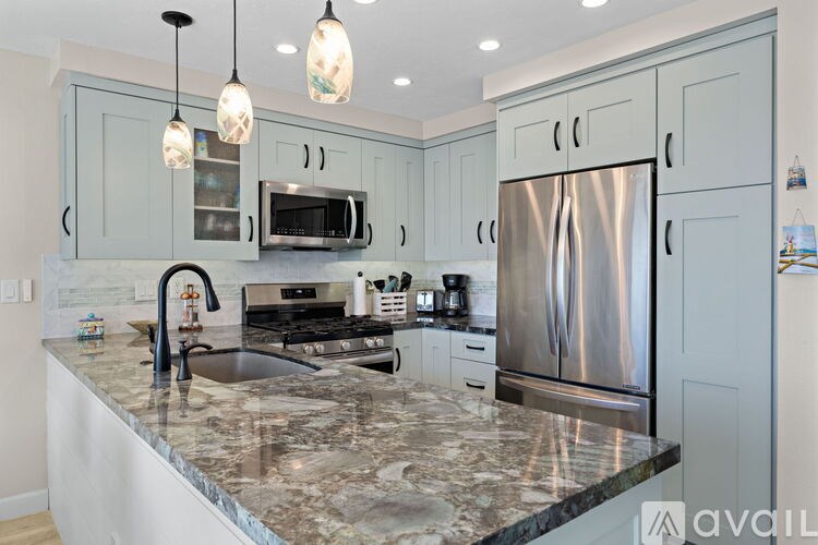 A kitchen with granite countertops and stainless steel appliances.