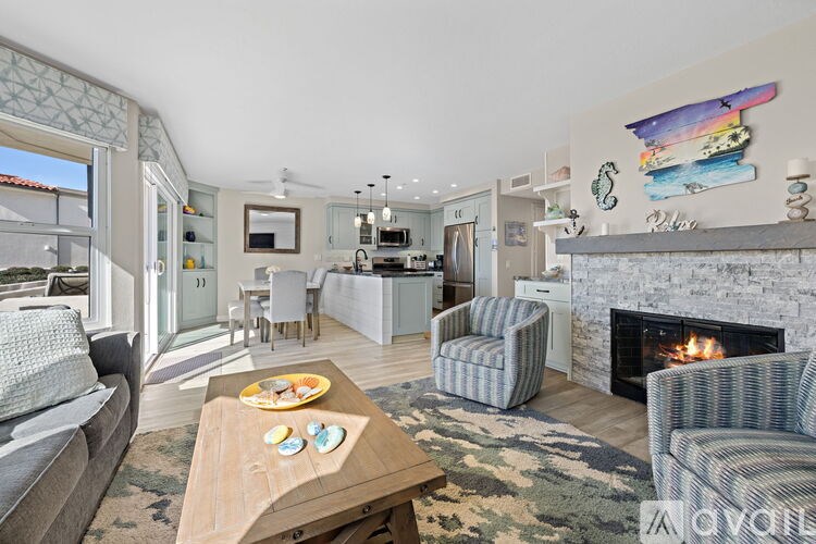 A living room with a fireplace and a painting on the wall.