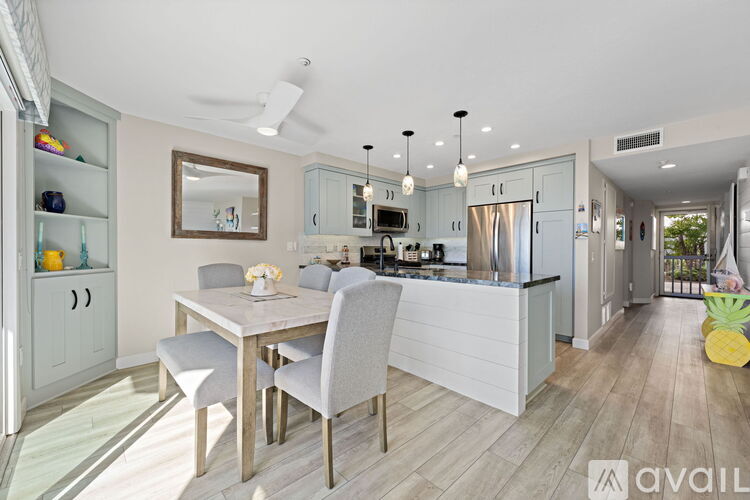 A modern kitchen with a dining table and chairs.