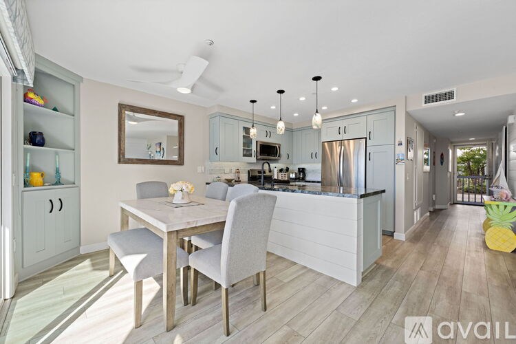 A modern kitchen with a dining table and chairs.