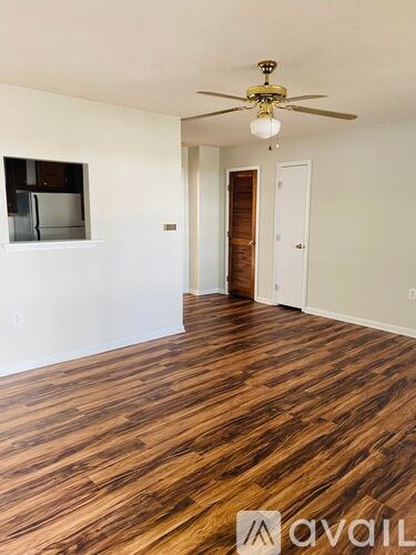 A room with wooden floors and white walls.