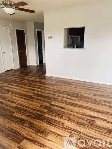 A room with wooden floors and white walls.