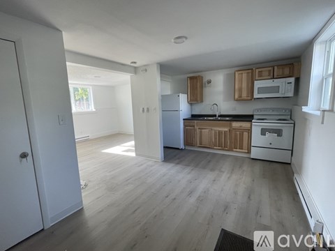 A kitchen with wooden cabinets and a white fridge.