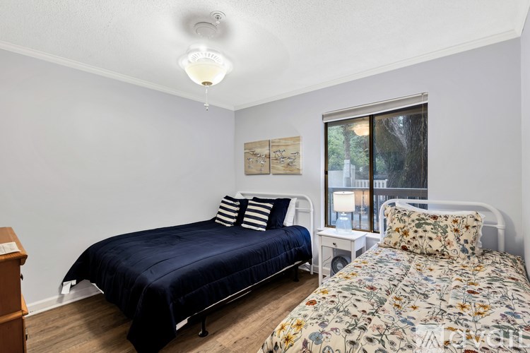 A bedroom with a bed and a nightstand.