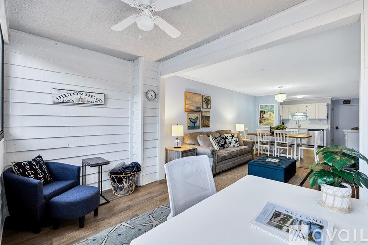 A living room with a white table and a blue couch.