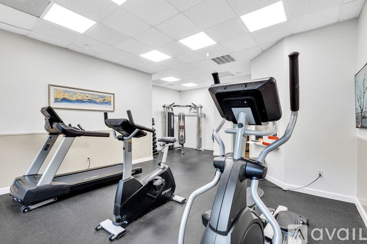 A gym with treadmills and elliptical machines.