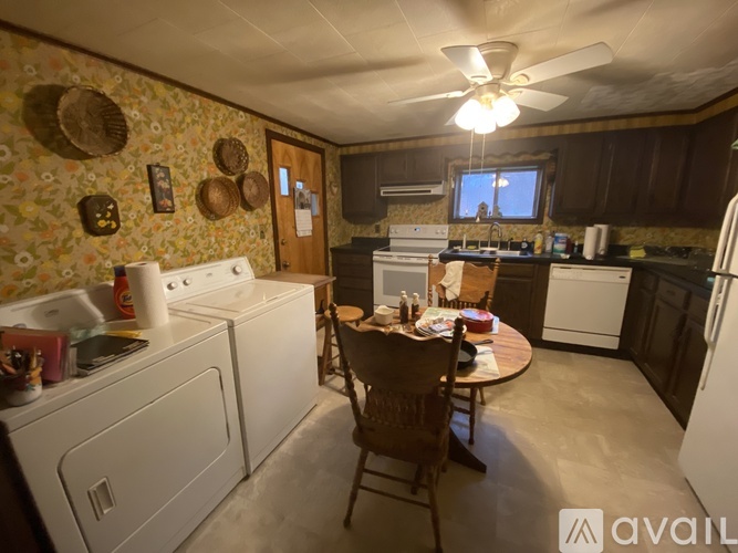 A kitchen with a table and chairs in the middle of it.