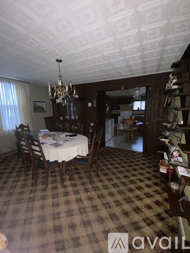 A dining room with a checkered floor and a chandelier.